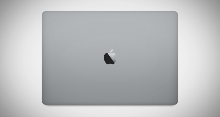 Khám Phá Ý Nghĩa Logo Apple: Bí Mật Đằng Sau Quả Táo Cắn Dở Máy tính xách tay màu bạc với logo táo cắn kim loại sáng bóng ở trung tâm